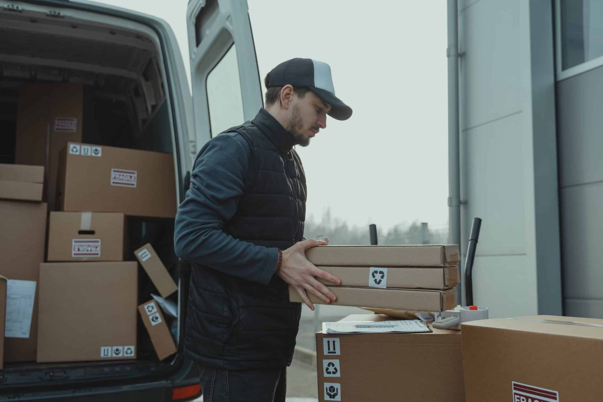 Free Shipping Banner Man loading packages into the back of a truck